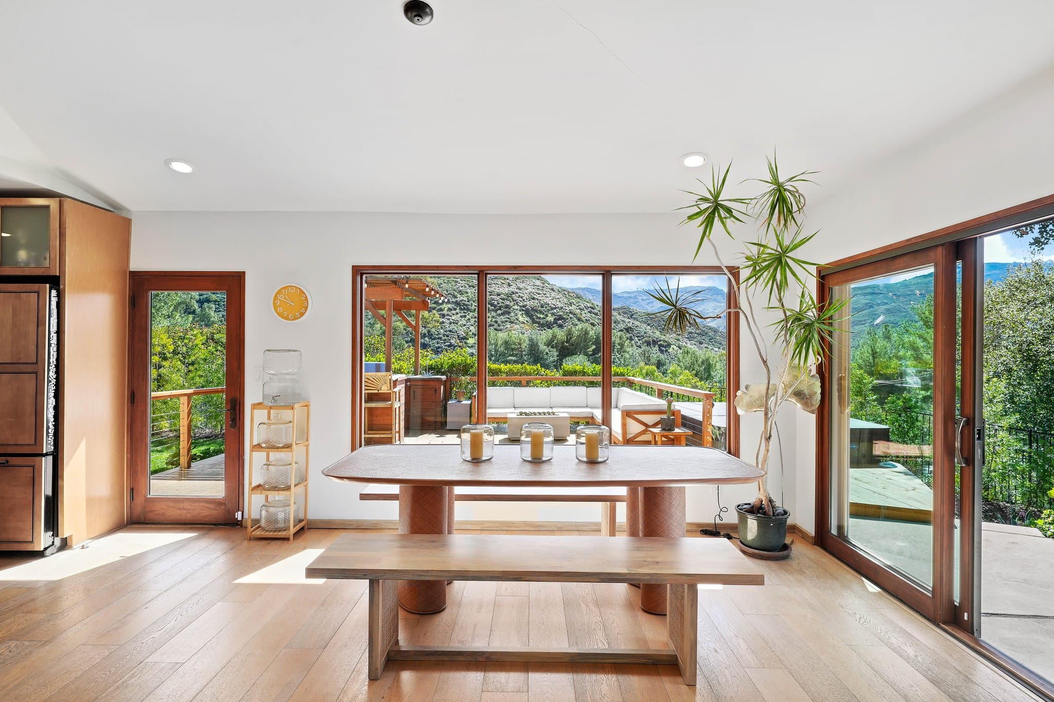 Dining room with wall-to-wall windows framing canyon mountain views
