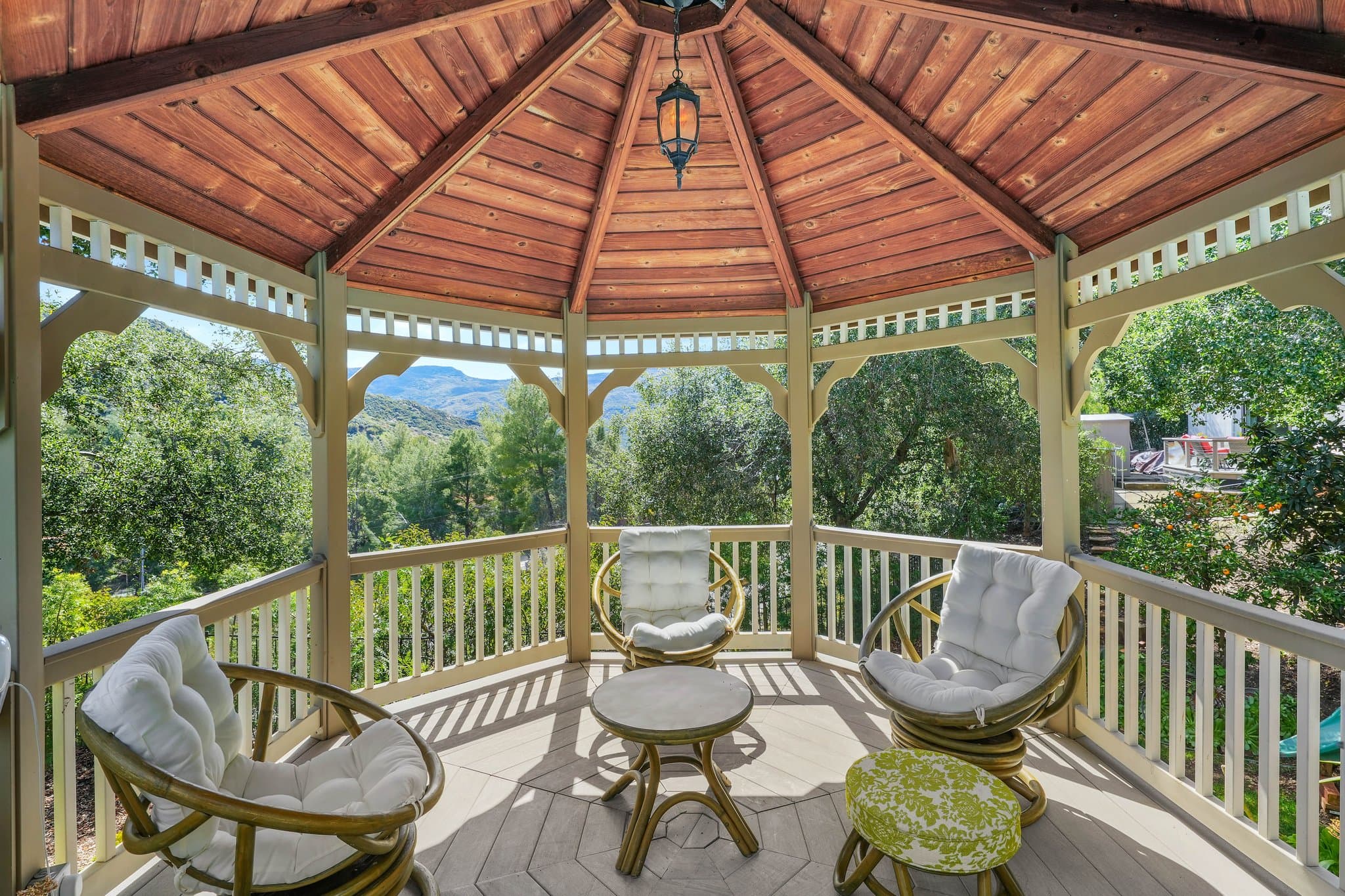 Inside the gazebo with wraparound mountain views and rattan seating